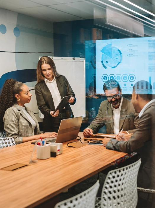 Business team in a modern office discussing data on a tablet.