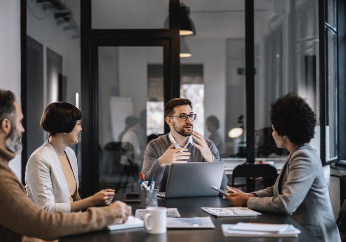 Business team discussing strategies in a modern office meeting.